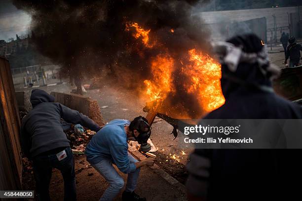 Palestinian youth clash with police at Shuafat refugee camp after a Palestinian resident of the camp was named as the driver of a van that rammed...