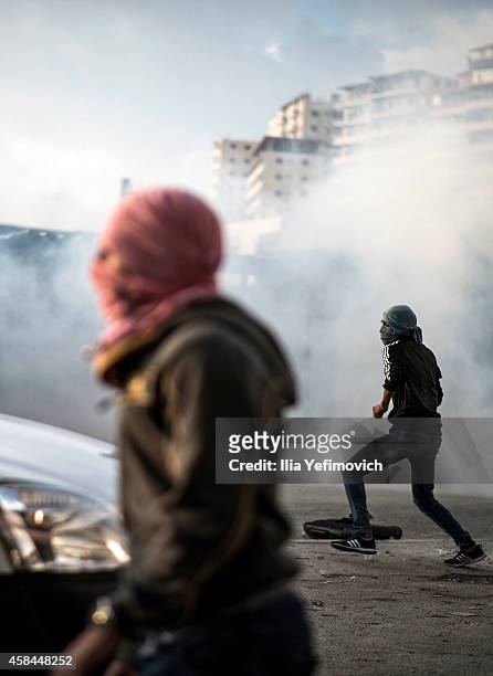 Palestinian youth clash with police at Shuafat refugee camp after a Palestinian resident of the camp was named as the driver of a van that rammed...