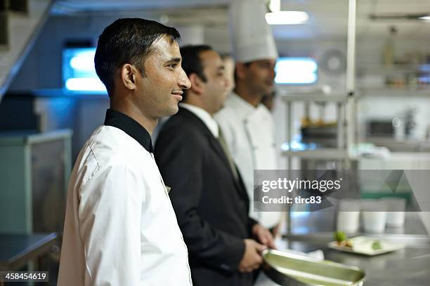 indian chefs in busy hotel kitchen - indian chef stock pictures, royalty-free photos & images