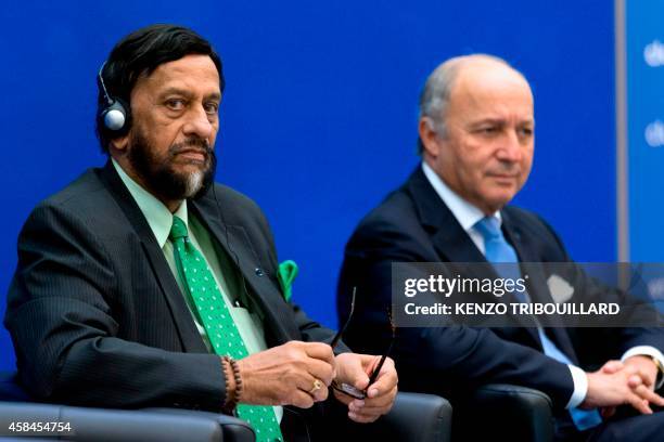 The head of the UN's climate science panel Rajendra Pachauri and French Foreign Affairs minister Laurent Fabius take part in a climate conference in...