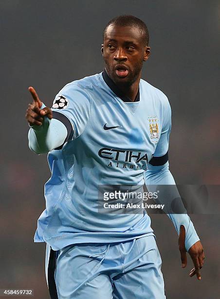 Yaya Toure of Manchester City celebrates scoring his team's first goal during the UEFA Champions League Group E match between Manchester City and...