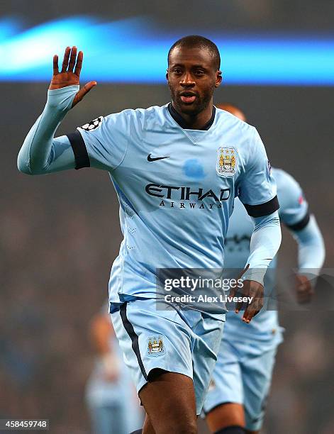 Yaya Toure of Manchester City celebrates scoring his team's first goal during the UEFA Champions League Group E match between Manchester City and...