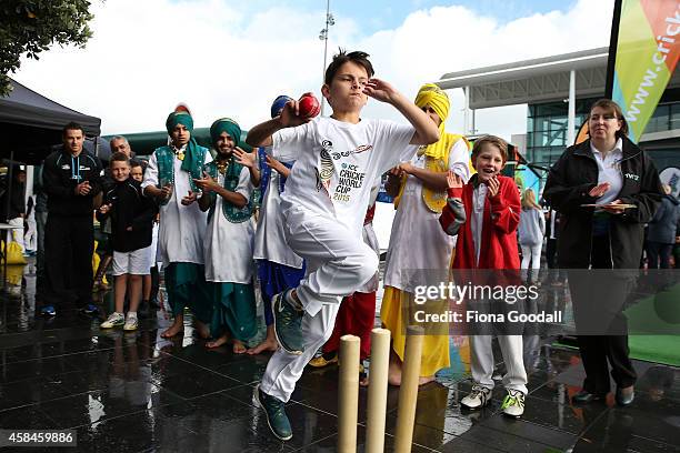 Shay Reid bowls watched by Black Cap Nathan McCullum during the 100 day countdown to the 2015 ICC Cricket World Cup at Wynyard Wharf on November 6,...