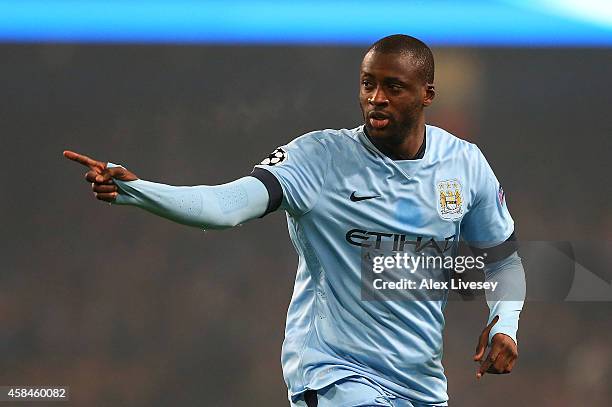 Yaya Toure of Manchester City celebrates scoring his team's first goal during the UEFA Champions League Group E match between Manchester City and...