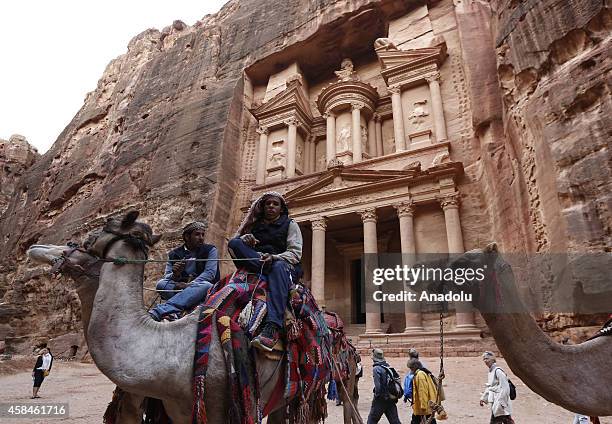 Jordanians mount camels in front of he facade of Al Khazneh , built as a royal tomb and so called after a legend that pirates hid their loot in an...