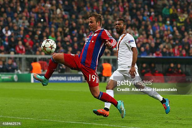 Mario Goetze of Bayern Muenchen scores their second goal as Ashley Cole of AS Roma looks on during the UEFA Champions League Group E match between FC...