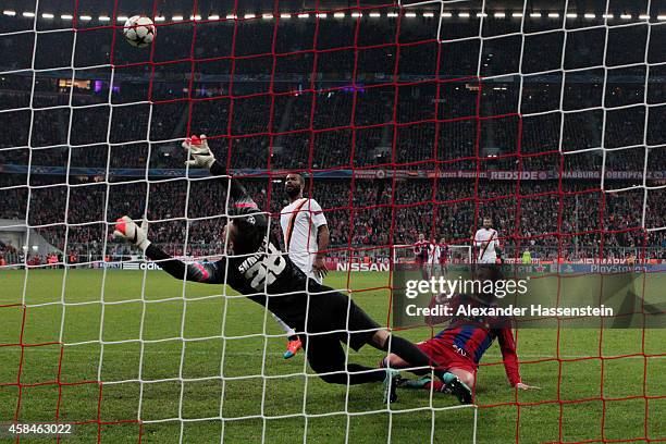 Mario Goetze of Bayern Muenchen shoots past goalkeeper Lukasz Skorupski of AS Roma to score their second goal during the UEFA Champions League Group...