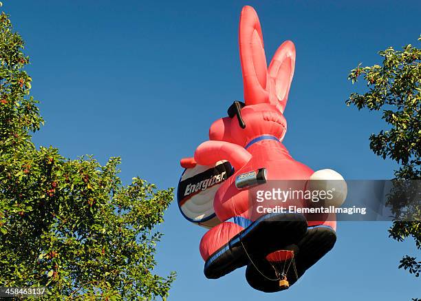 energizer bunny hot air balloon at sunrise over tree topd - energizer bunny stock pictures, royalty-free photos & images