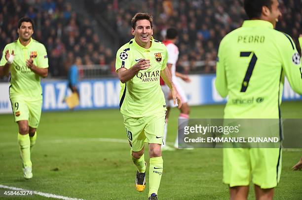 Barcelona's Argentinian forward Lionel Messi celebrates after scoring his second goal during the UEFA Champions League football match between Ajax...