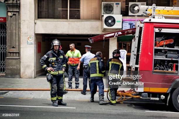 fire-fighters next to fire-engine - firelighter stock pictures, royalty-free photos & images