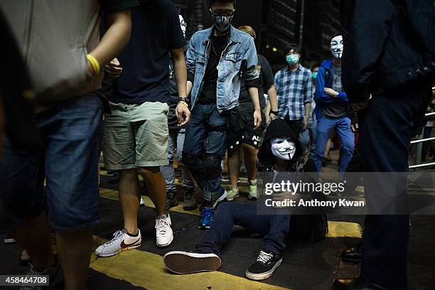 Pro-democracy protester sits at a crosswalk of a street in Central district on November 5, 2014 in Hong Kong. Pro-democracy protesters staged a rally...