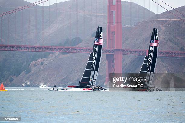 two of oracle team usa's  america's cup catamaran training - americas cup training stockfoto's en -beelden