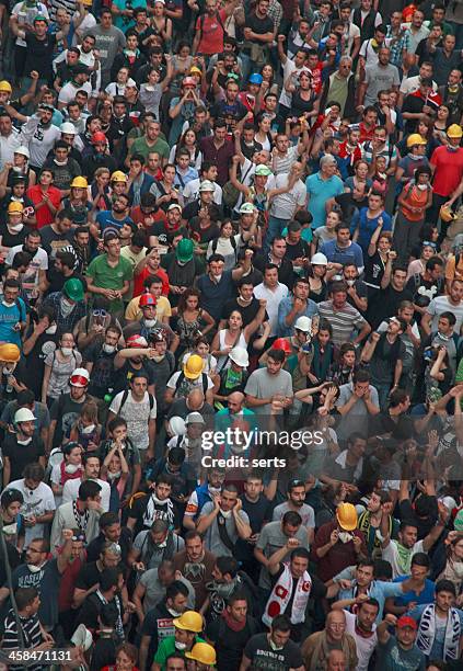 crowd of walking people - taksim gezi park stock pictures, royalty-free photos & images