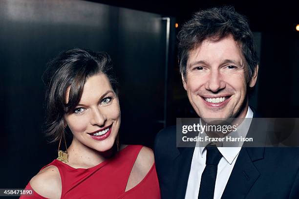 Milla Jovovich and Paul W.S. Anderson pose for a portrait at the amfAR LA Inspiration Gala on October 29, 2014 in Los Angeles, California.