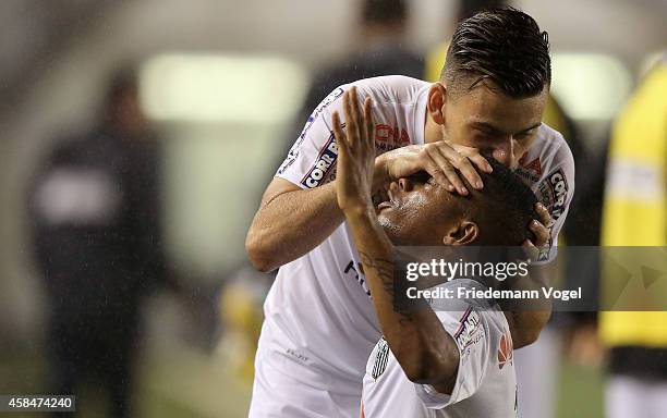 Robinho of Santos celebrates scoring the first goal with Alison during the match between Santos and Cruzeiro for Copa do Brasil 2014 at Vila Belmiro...