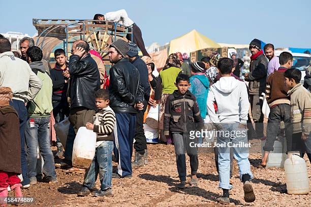 syrian refugees waiting for water at idp camp - exile bildbanksfoton och bilder
