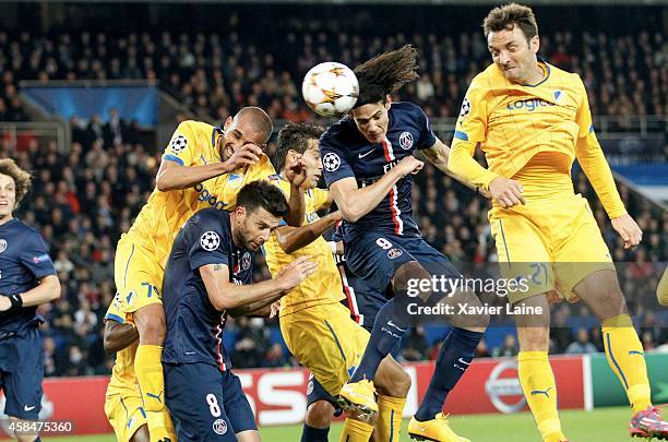 Edinson Cavani of Paris Saint-Germain jump over Thiago Motta, Rafik Djebbour and Gustavo Manduca of APOEL Nicosie during the UEFA Champions League...