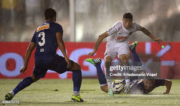 Rildo of Santos fights for the ball with Ceara of Cruzeiro during the match between Santos and Cruzeiro for Copa do Brasil 2014 at Vila Belmiro...