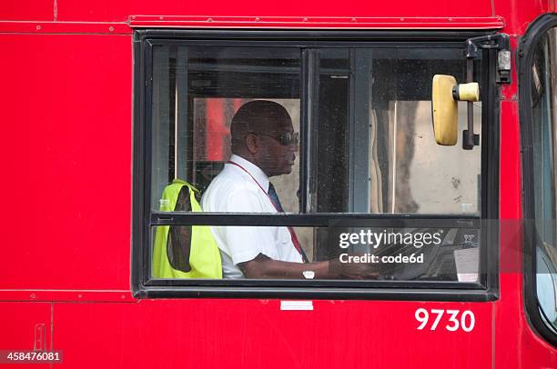 driver of a red bus in central london - bus driver stock pictures, royalty-free photos & images