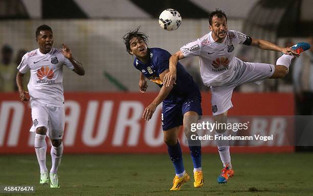 Edu Dracena of Santos fights for the ball with Marcelo Moreno of Cruzeiro during the match between Santos and Cruzeiro for Copa do Brasil 2014 at...