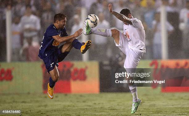 Rildo of Santos fights for the ball with Everton of Cruzeiro during the match between Santos and Cruzeiro for Copa do Brasil 2014 at Vila Belmiro...