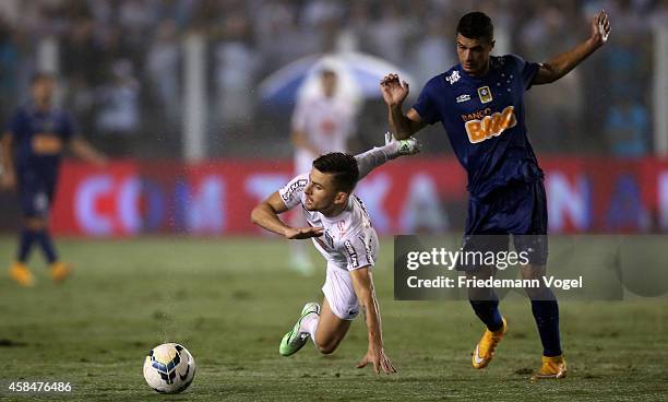 Lucas Lima of Santos fights for the ball with Egidio of Cruzeiro during the match between Santos and Cruzeiro for Copa do Brasil 2014 at Vila Belmiro...