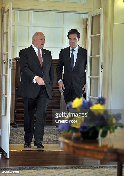 Australian Governor-General Peter Cosgrove walks with the Netherlands Prime Minister Mark Rutte before signing the visitors book at Government House...