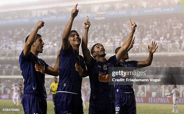 The team of Cruzeiro celebrates scoring the second goal during the match between Santos and Cruzeiro for Copa do Brasil 2014 at Vila Belmiro Stadium...