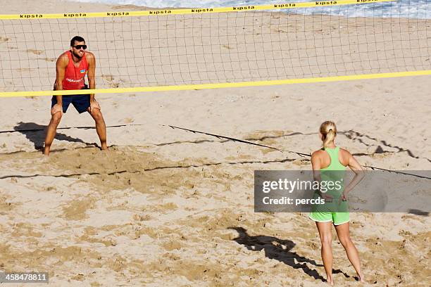 playing beach volleyball - pelota stockfoto's en -beelden