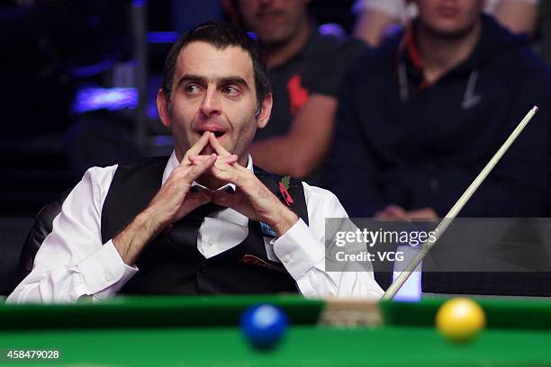 Ronnie O'Sullivan of England reacts against Stuart Bingham of England during their 1/8 match on day three of 2014 Dafabet Champion of Champions at...