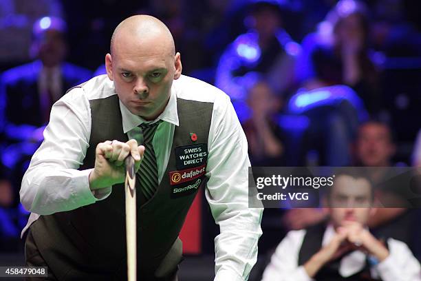 Stuart Bingham of England plays a shot against Ronnie O'Sullivan of England during their 1/8 match on day three of 2014 Dafabet Champion of Champions...