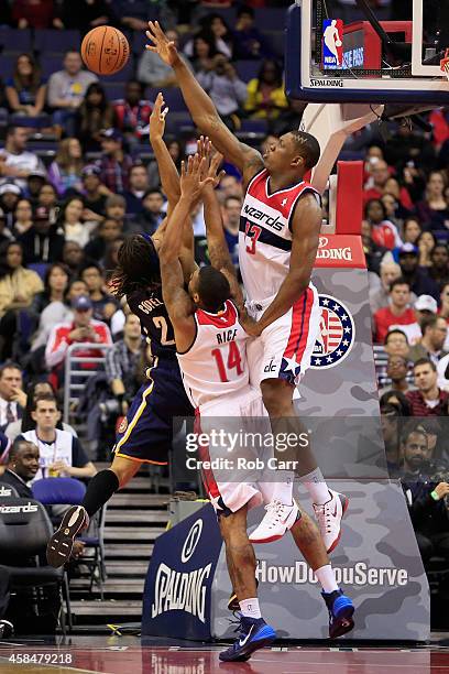 Kevin Seraphin and Glen Rice Jr. #14 of the Washington Wizards defend a shot by Chris Copeland of the Indiana Pacers during the first half at Verizon...