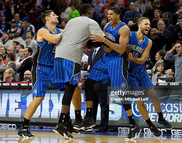Tobias Harris of the Orlando Magic reacts with Nikola Vucevic and Evan Fournier after Harris made the game winning jump shot at the buzzer to defeat...