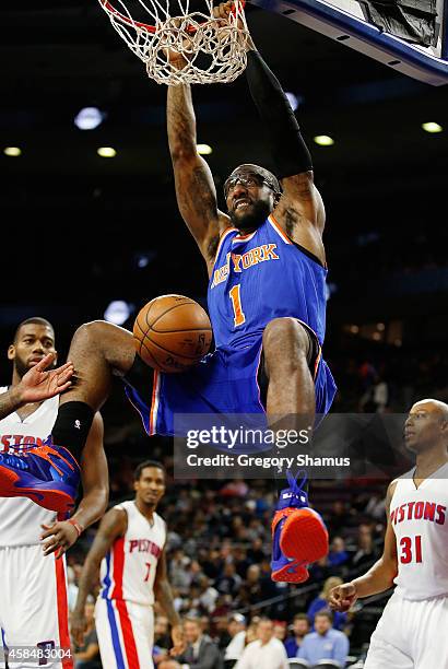 Amar'e Stoudemire of the New York Knicks gets in for a second half dunk net to Caron Butler of the Detroit Pistons at the Palace of Auburn Hills on...