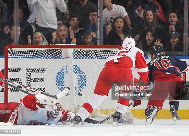 Derick Brassard of the New York Rangers scores the game winning goal in overtime against Jonas Gustavsson of the Detroit Red Wings at Madison Square...