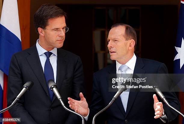Prime Minister of The Netherlands Mark Rutte reacts as he listens to Australian Prime Minster Tony Abbott speak during a media conference at...