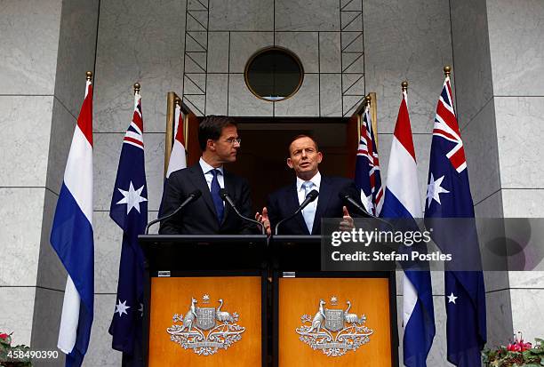Prime Minister of The Netherlands Mark Rutte listens to Australian Prime Minster Tony Abbott speak during a media conference at Parliament House...