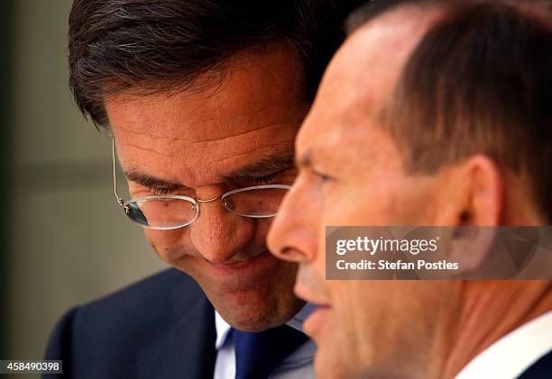 Prime Minister of The Netherlands Mark Rutte reacts as he listens to Australian Prime Minster Tony Abbott speak during a media conference at...