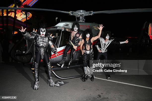 Singer/bassist Gene Simmons, drummer Eric Singer, singer/guitarist Paul Stanley and guitarist Tommy Thayer of Kiss pose after arriving by helicopter...