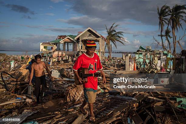 People walk through a destroyed neighbourhood in Tacloban City following the recent super typhoon on November 17, 2013 in Leyte, Philippines. Typhoon...