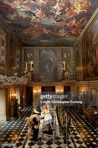 Chatsworth House staff members Ellie Cooper, aged 19, and Tim Greaves, pose as Alice in Wonderland and the Mad Hatter as they recreate the Mad...