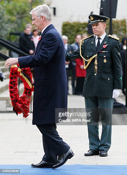Belgium's King Philippe holds a wreath during the Opening of the Flanders' Fields Memorial Garden at Wellington Barracks on November 6, 2014 in...