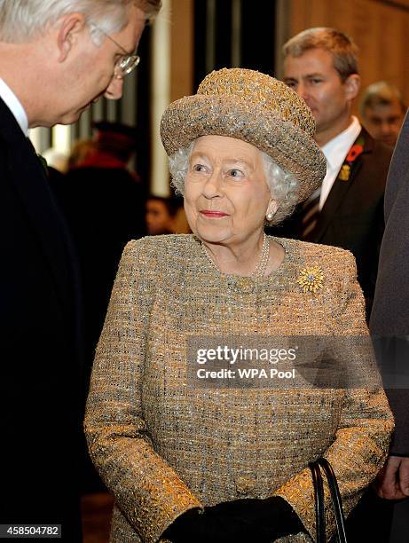 Queen Elizabeth II talks to King Philippe of Belgium after the opening of the Flanders' Fields Memorial Garden on November 6, 2014 in London, England.