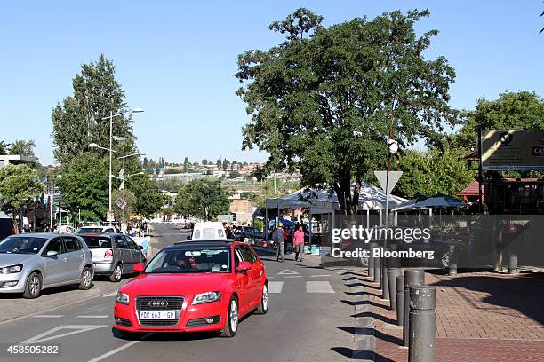 Resident drives a red Audi AG automobile along Vilakazi street in Soweto, South Africa, on Wednesday, Nov. 5, 2014. Township economies have the...