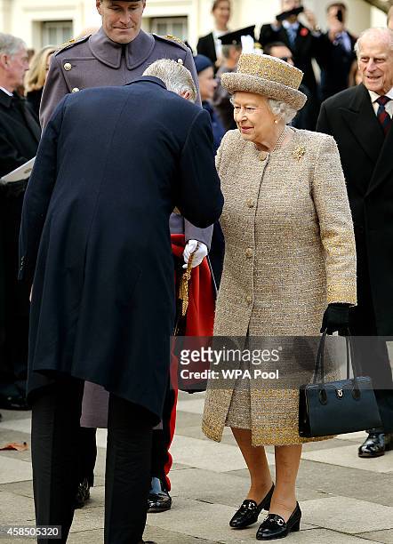 King Philippe of Belgium kisses the hand of Queen Elizabeth II as they attend the opening of the Flanders' Fields Memorial Garden on November 6, 2014...