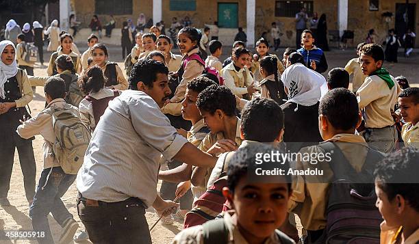 Egyptian students go to their classes at a primary school, where nearly 2 thousand students get education, after the Egyptian national anthem...