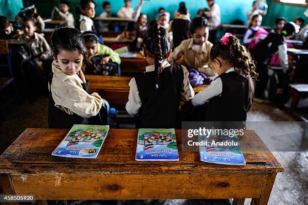 Egyptian students get prepared ahead of a lesson at their classes at a primary school, where nearly 2 thousand students get education, after the...