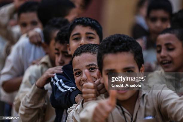 Egyptian students reacts as they are going to their classes at a primary school, where nearly 2 thousand students get education, after the Egyptian...