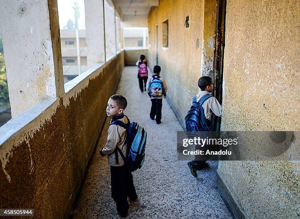 Egyptian students go to their classes at a primary school, where nearly 2 thousand students get education, after the Egyptian national anthem...