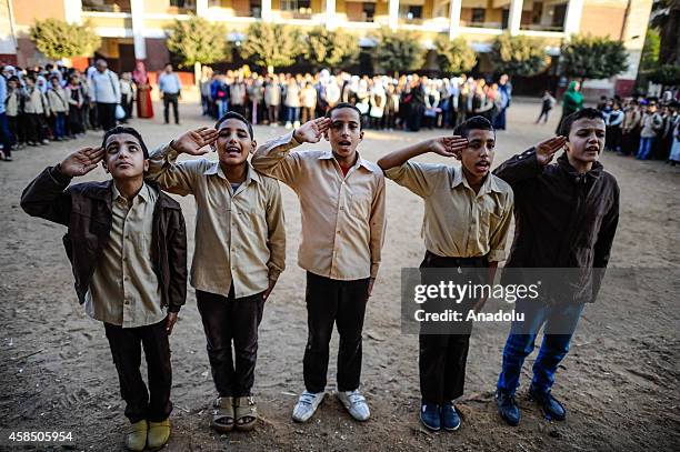 Egyptian students are seen at the garden of a primary school, where nearly 2 thousand students get education, during the Egyptian national anthem...